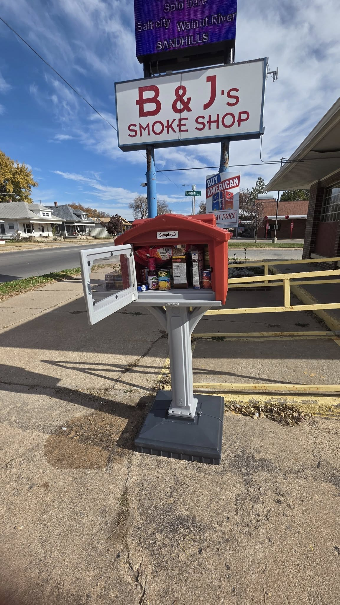 Community food pantry box installed outside local smoke shop