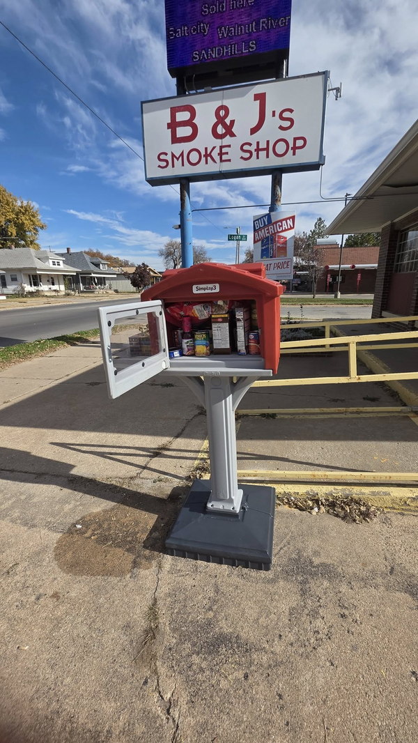 Community food pantry box installed outside local smoke shop